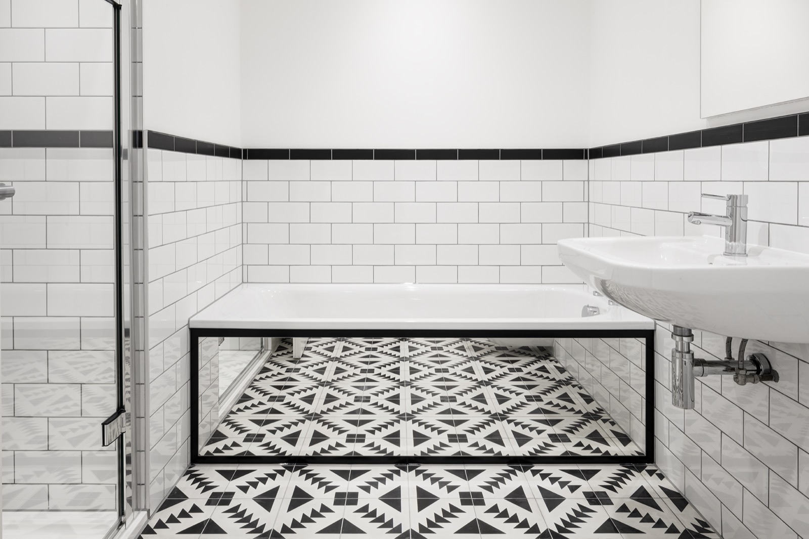 Bathroom with metro tiles and a patterned floor