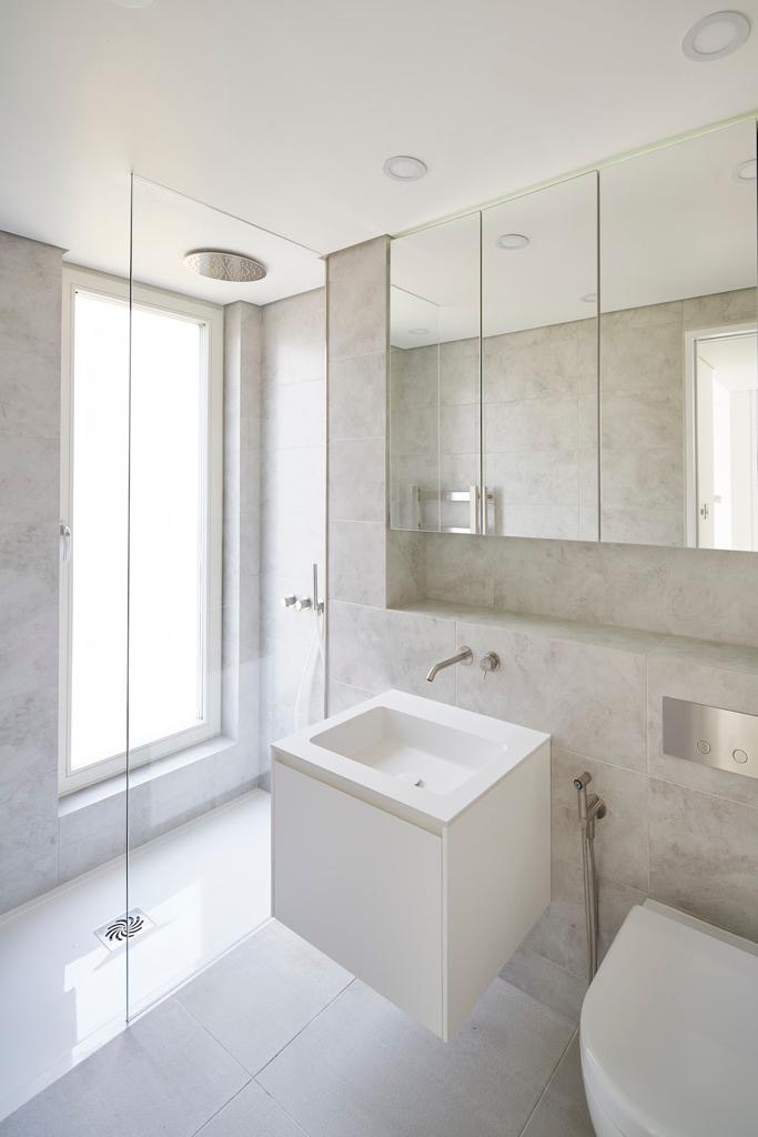 Stone-tiled bathroom with a wall-hung basin