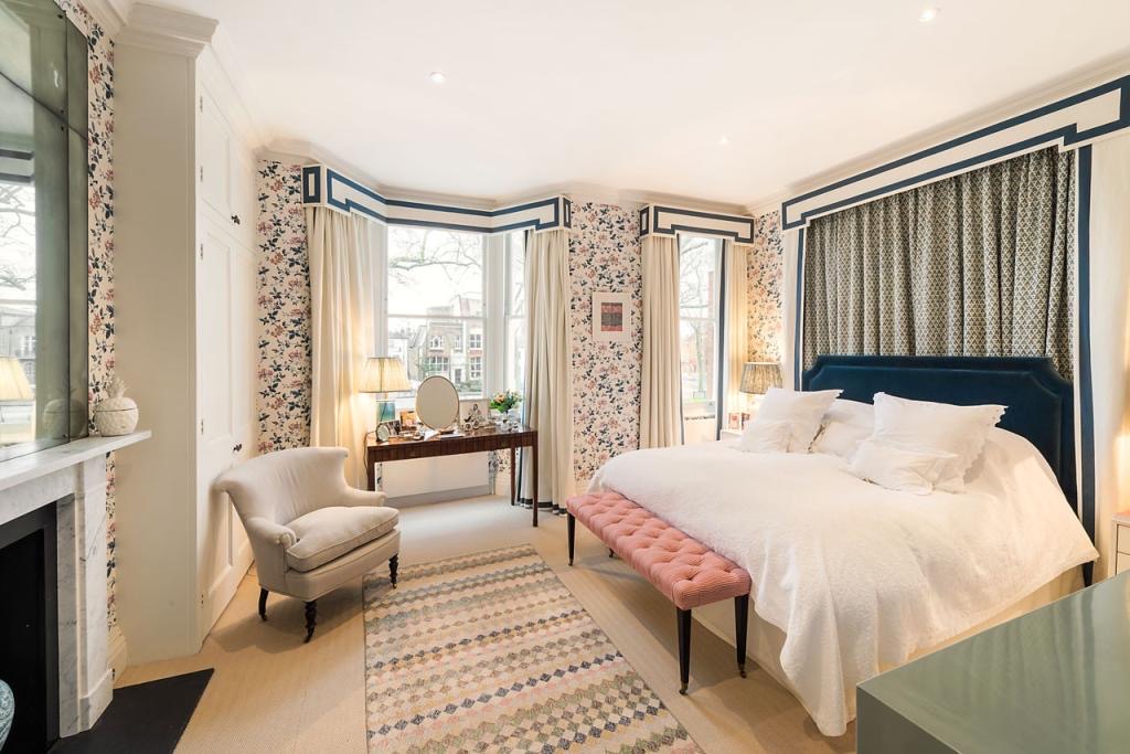 Bedroom with bay window and fireplace