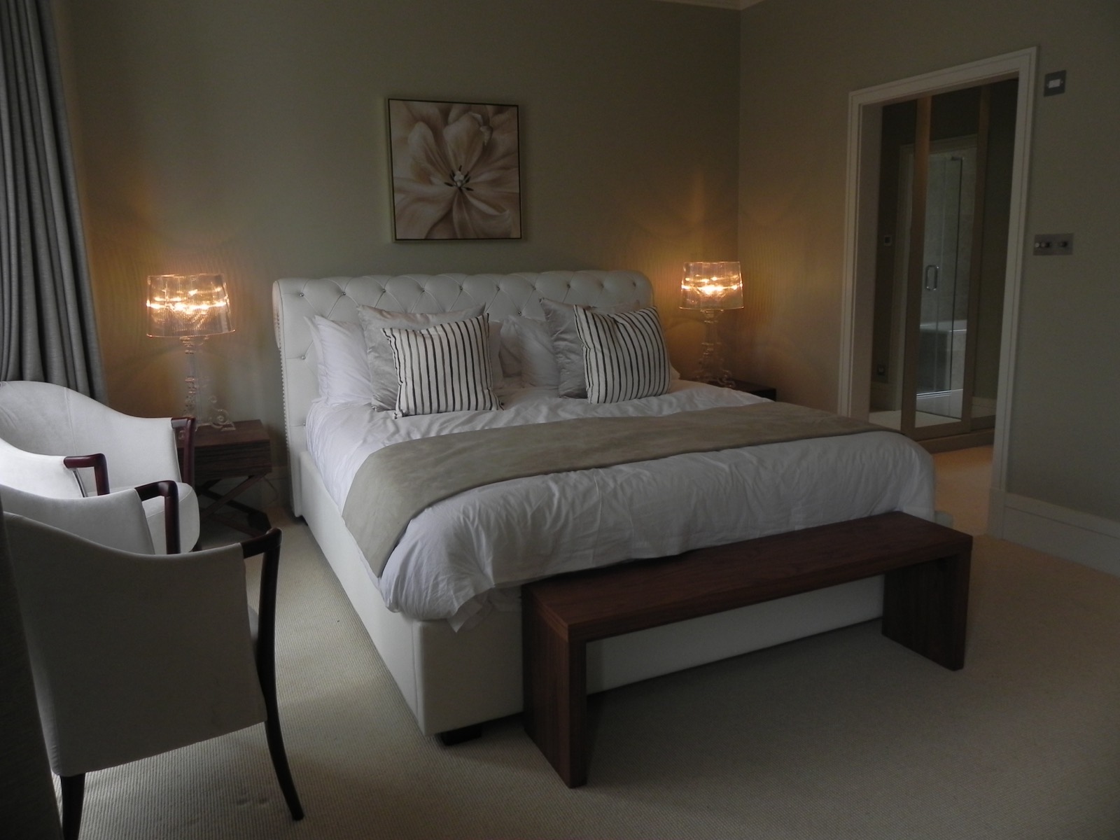 Bedroom with upholstered bed and wall lights