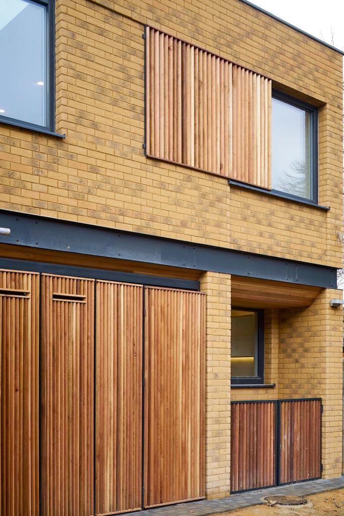Brick facade with sliding timber screens
