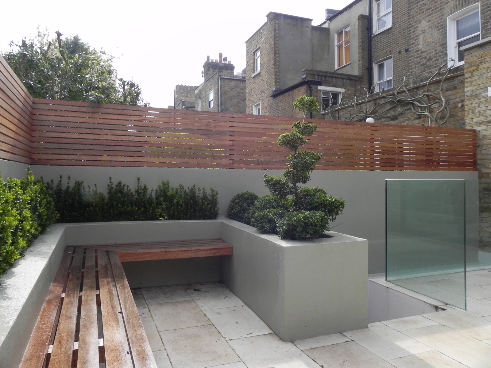 Courtyard garden with a built-in bench and planters