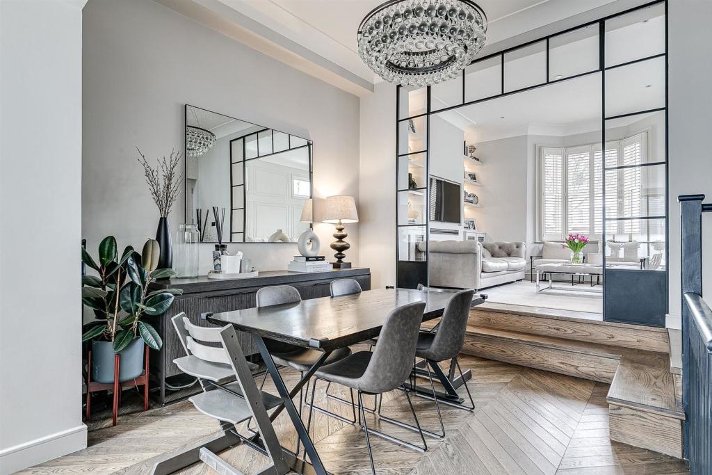 Dining area beside a steel-framed glazed screen