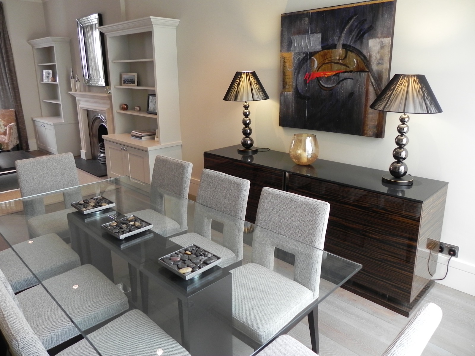 Dining room with a glass table and bespoke shelving