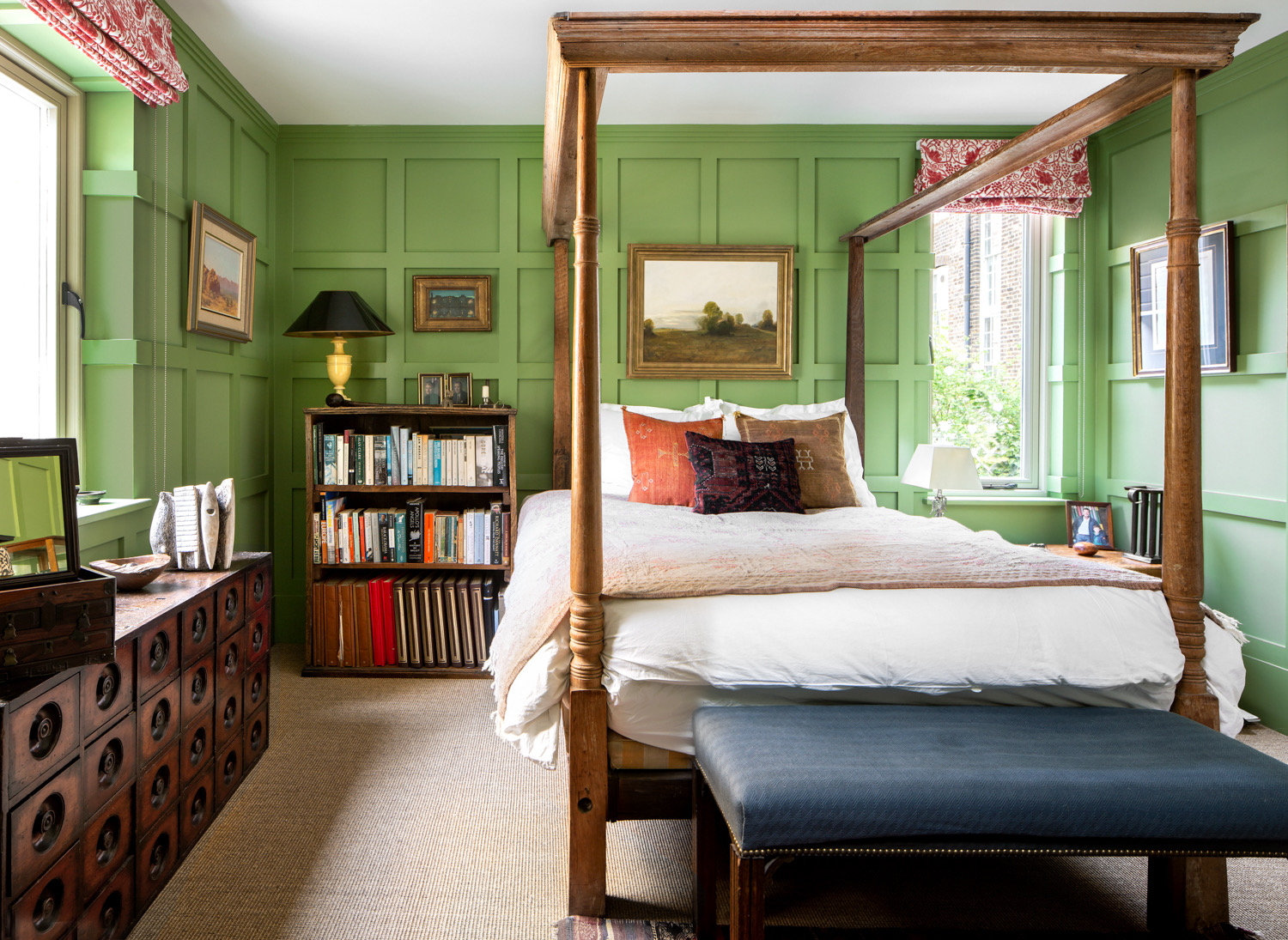 Green panelled bedroom with a four-poster bed