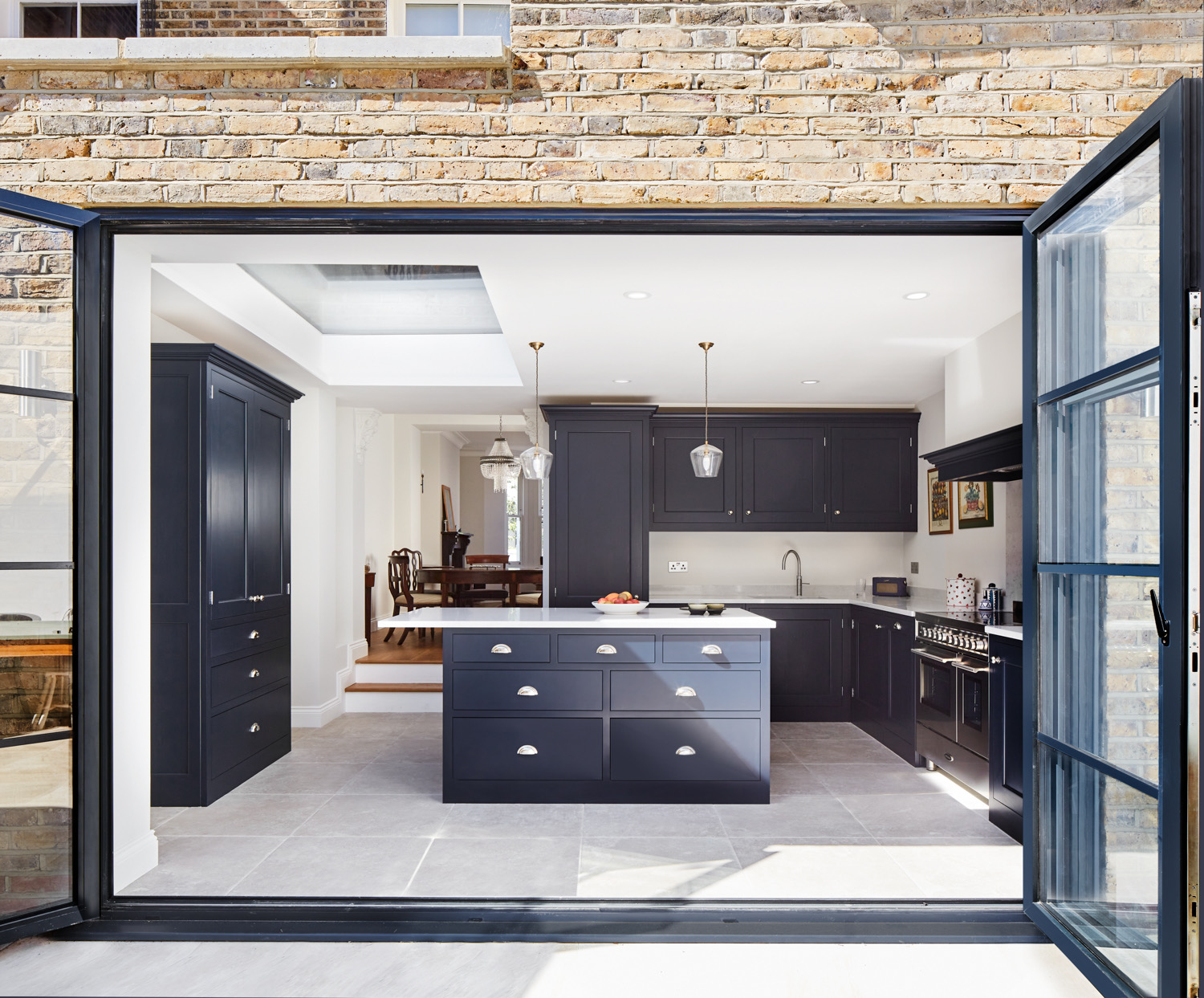 Kitchen extension with steel-framed doors open to the garden
