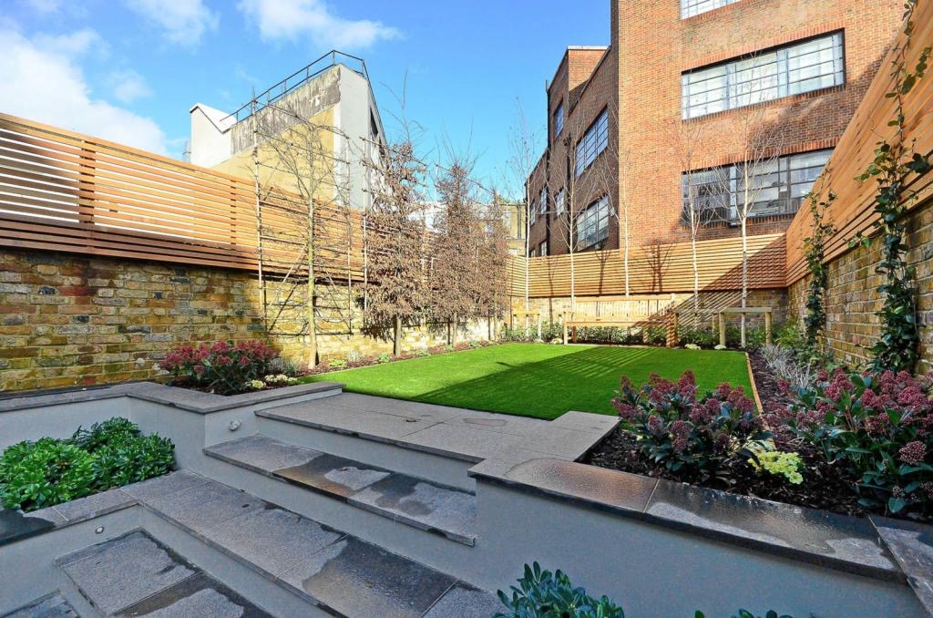 Landscaped garden with a stepped terrace and lawn