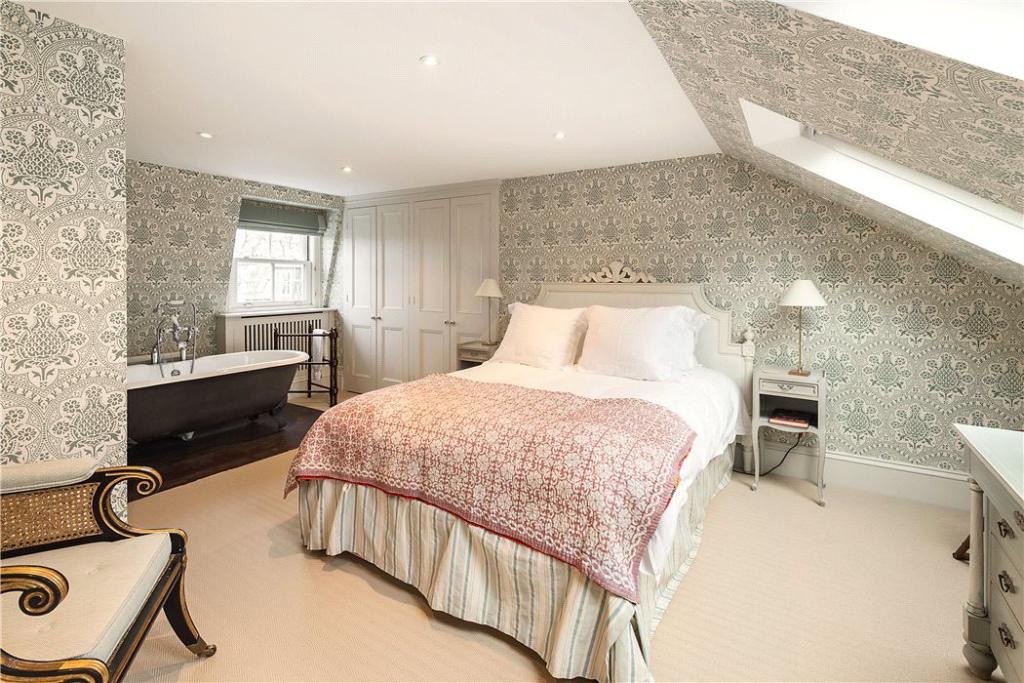 Loft bedroom with a freestanding bath