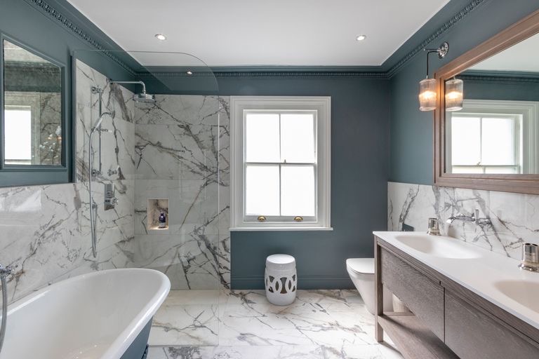 Marble bathroom with a freestanding bath and walk-in shower
