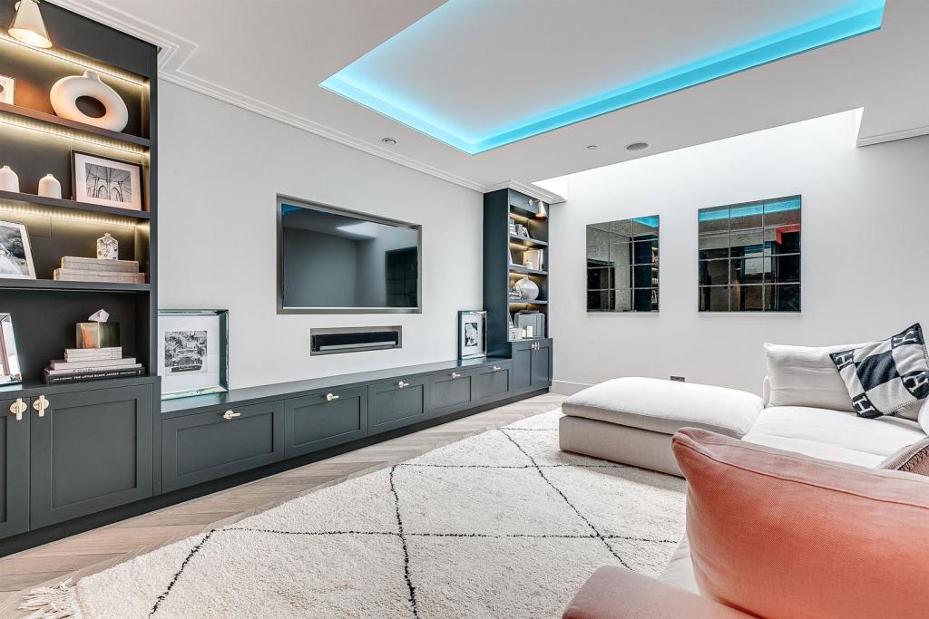 Media room with dark fitted cabinetry