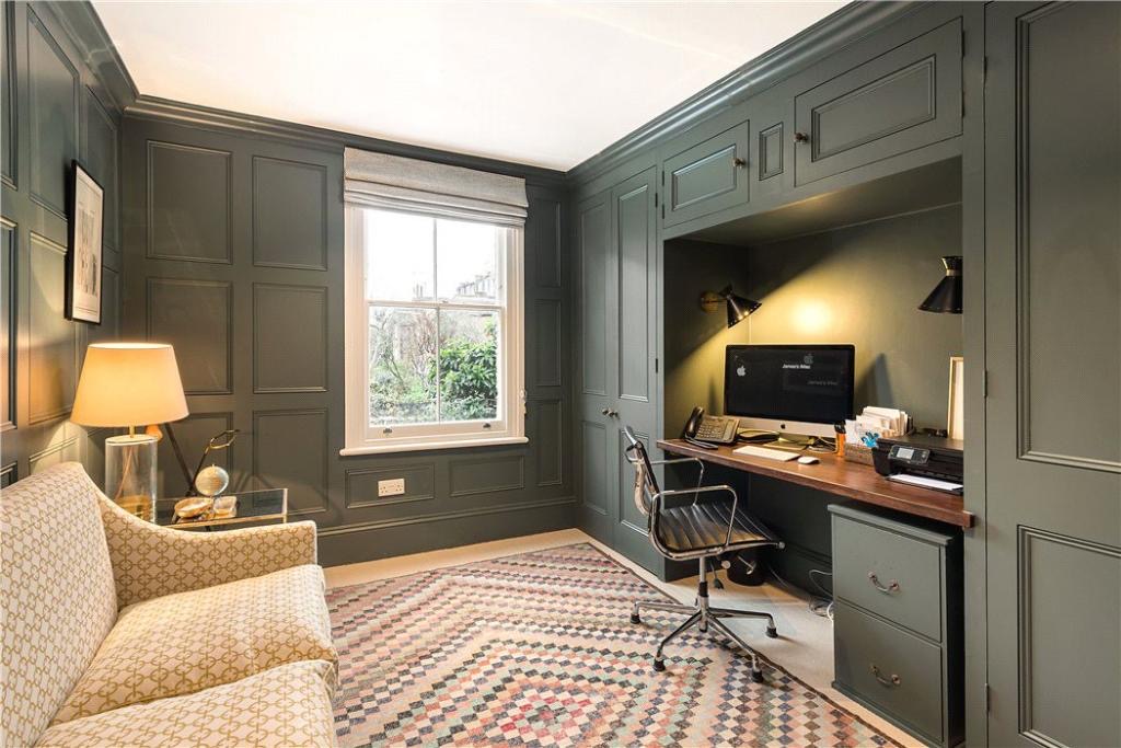Dark panelled study with a fitted desk