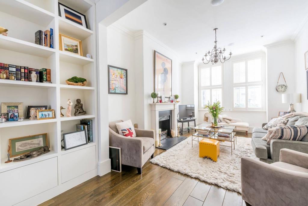 Reception room with fitted bookshelves and fireplace