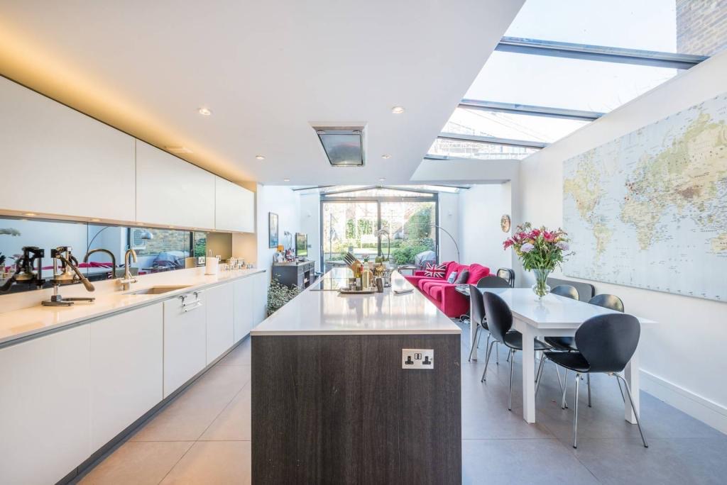 Side return kitchen with a glazed roof and long island