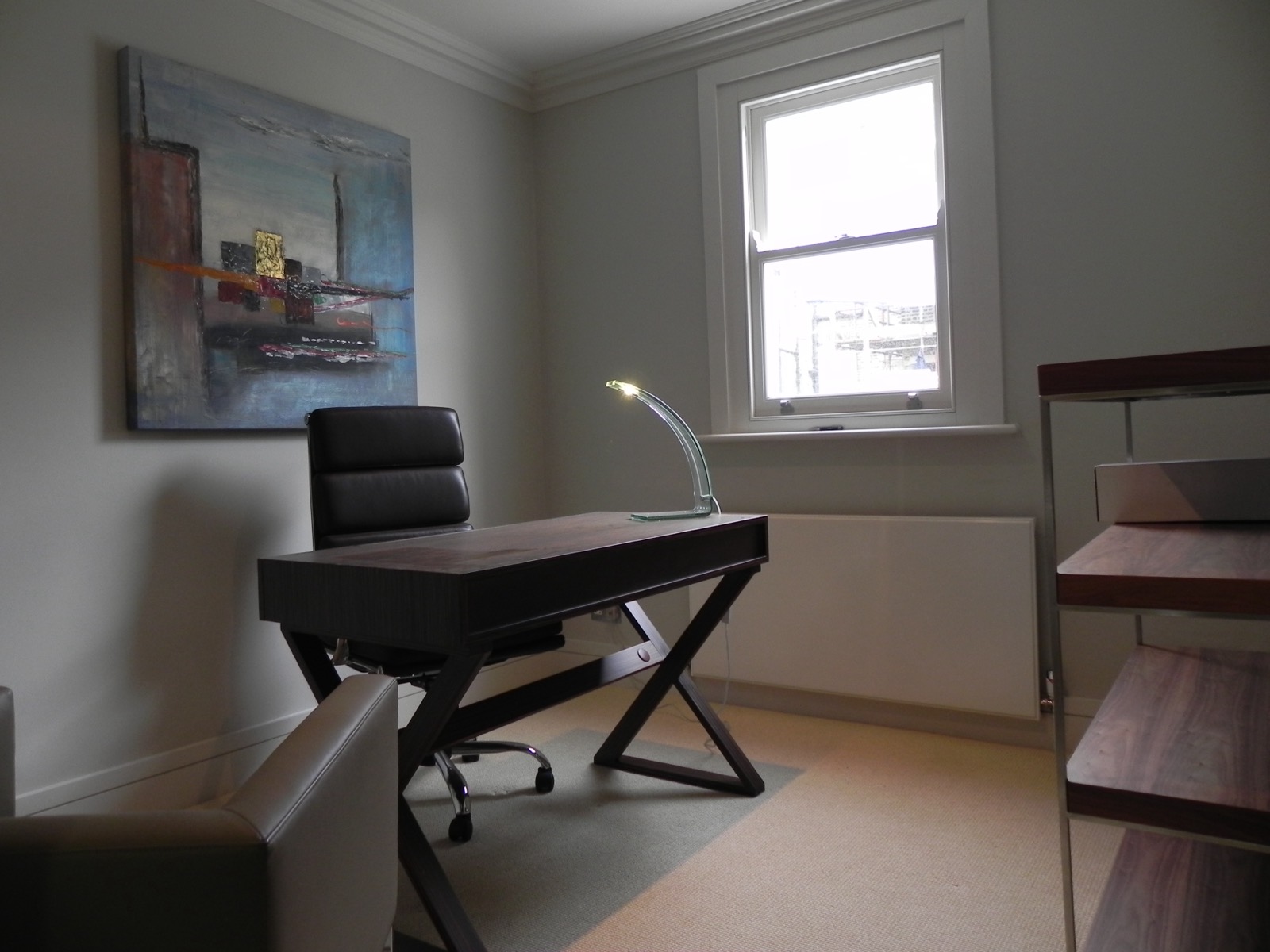Study with a desk beneath a sash window