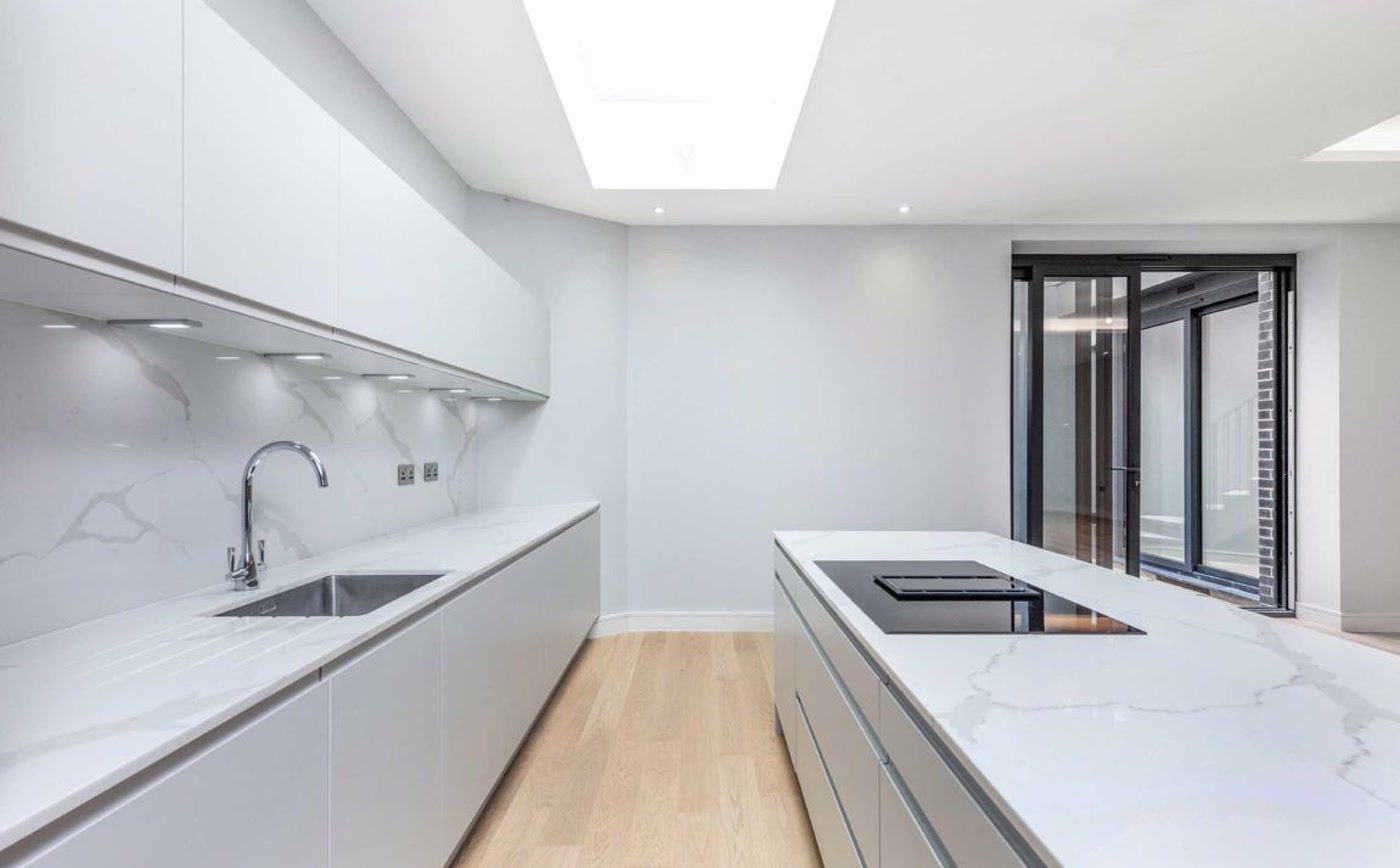 Handleless kitchen under a rooflight in Wanstead
