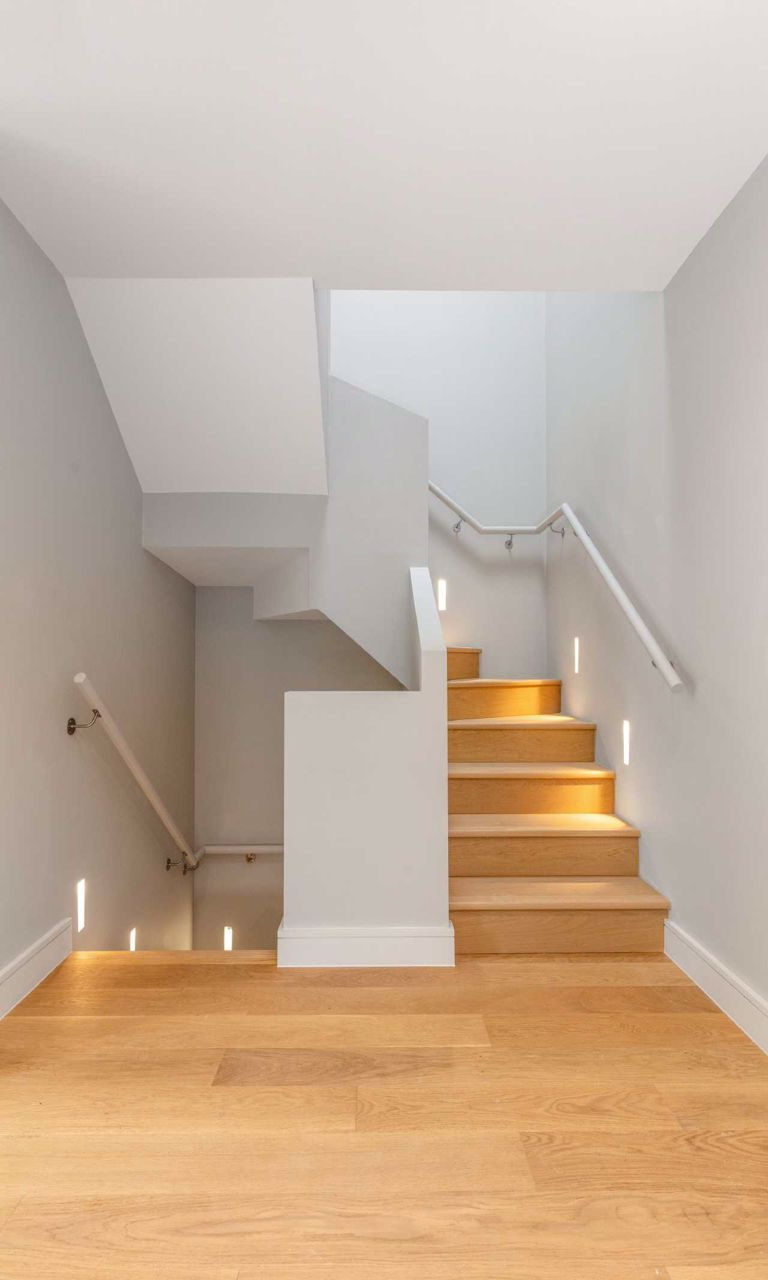 Oak staircase with lit treads in Epping
