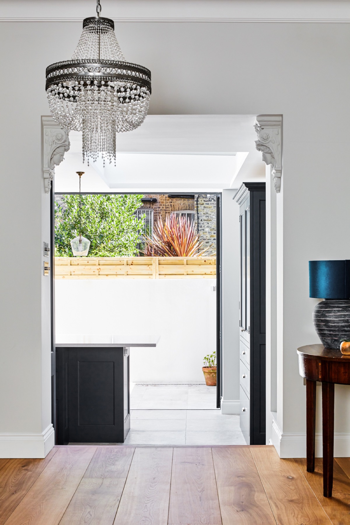 View from the hallway through to a kitchen extension and garden, kitchen extension in Chigwell