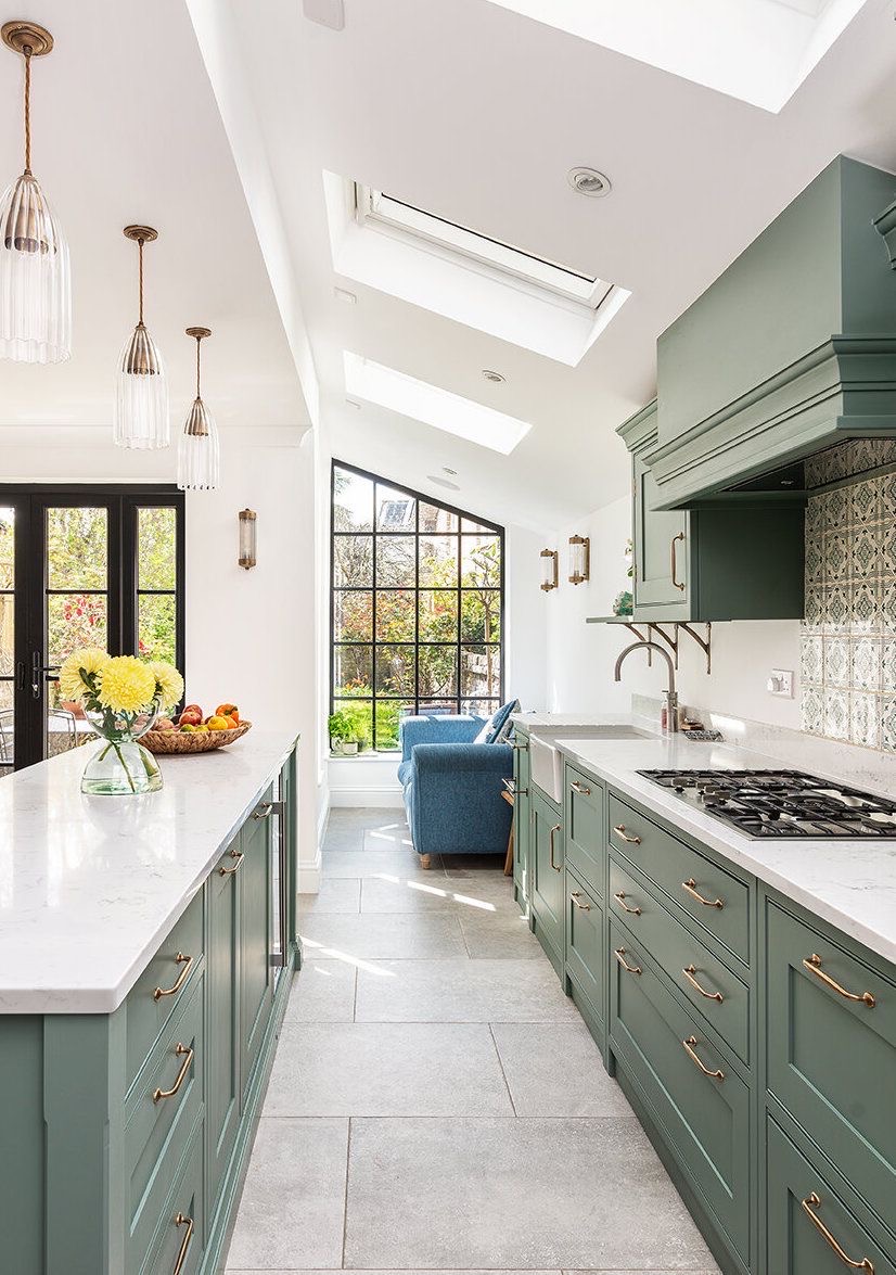 Green shaker kitchen with rooflights, pendant lights and steel-framed gable glazing