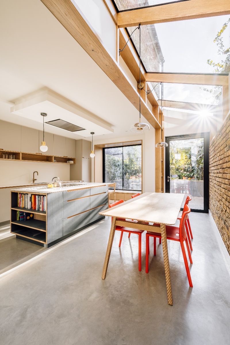 Kitchen extension with an oak-framed glazed roof, a freestanding island and a polished concrete floor