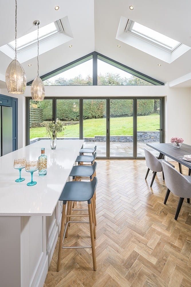 Vaulted kitchen extension with gable glazing, rooflights, bifold doors and a herringbone floor