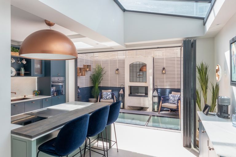 Kitchen with bifold doors opening onto a courtyard, kitchen extension in Wanstead