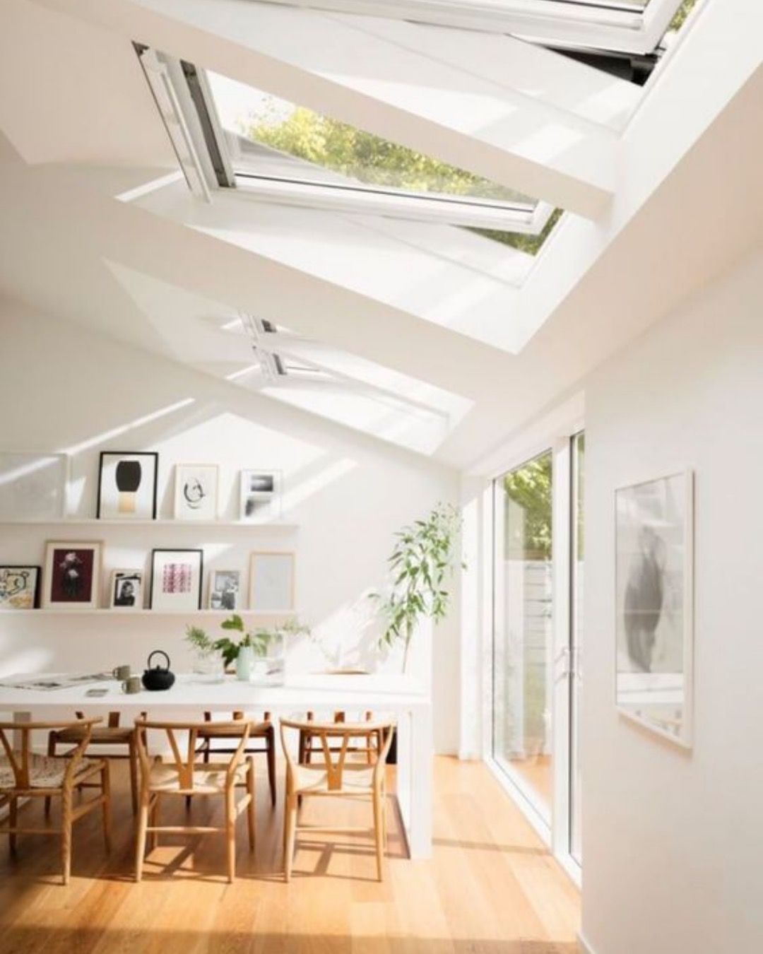 White vaulted dining space with rooflights and sliding doors