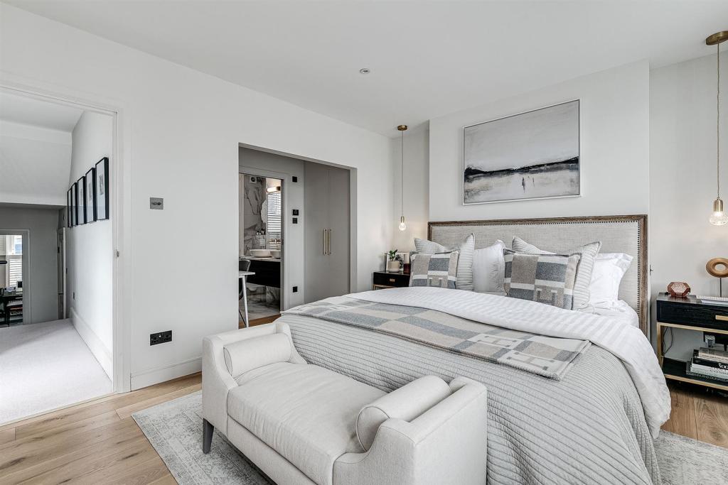 Principal bedroom with upholstered headboard, loft conversion in Brentwood