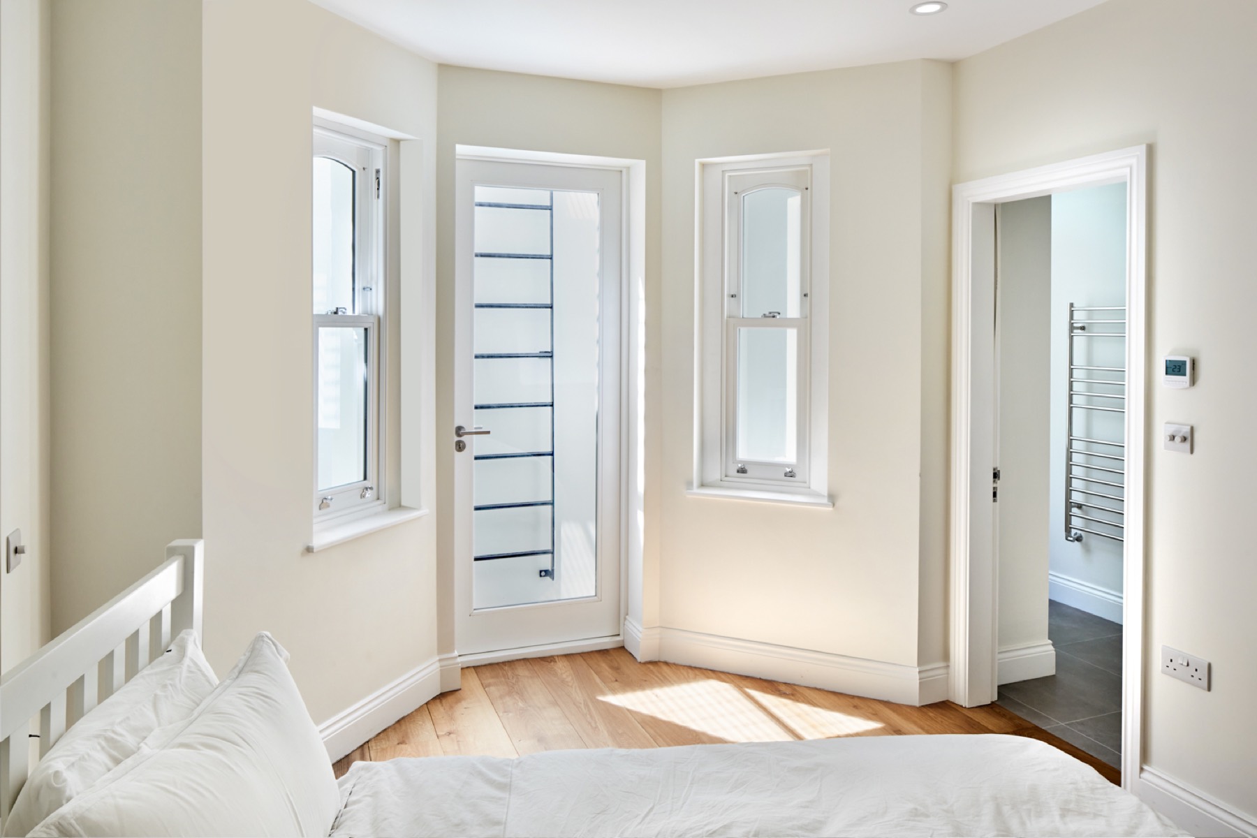 Bedroom with glazed door and en suite, loft conversion in Chigwell