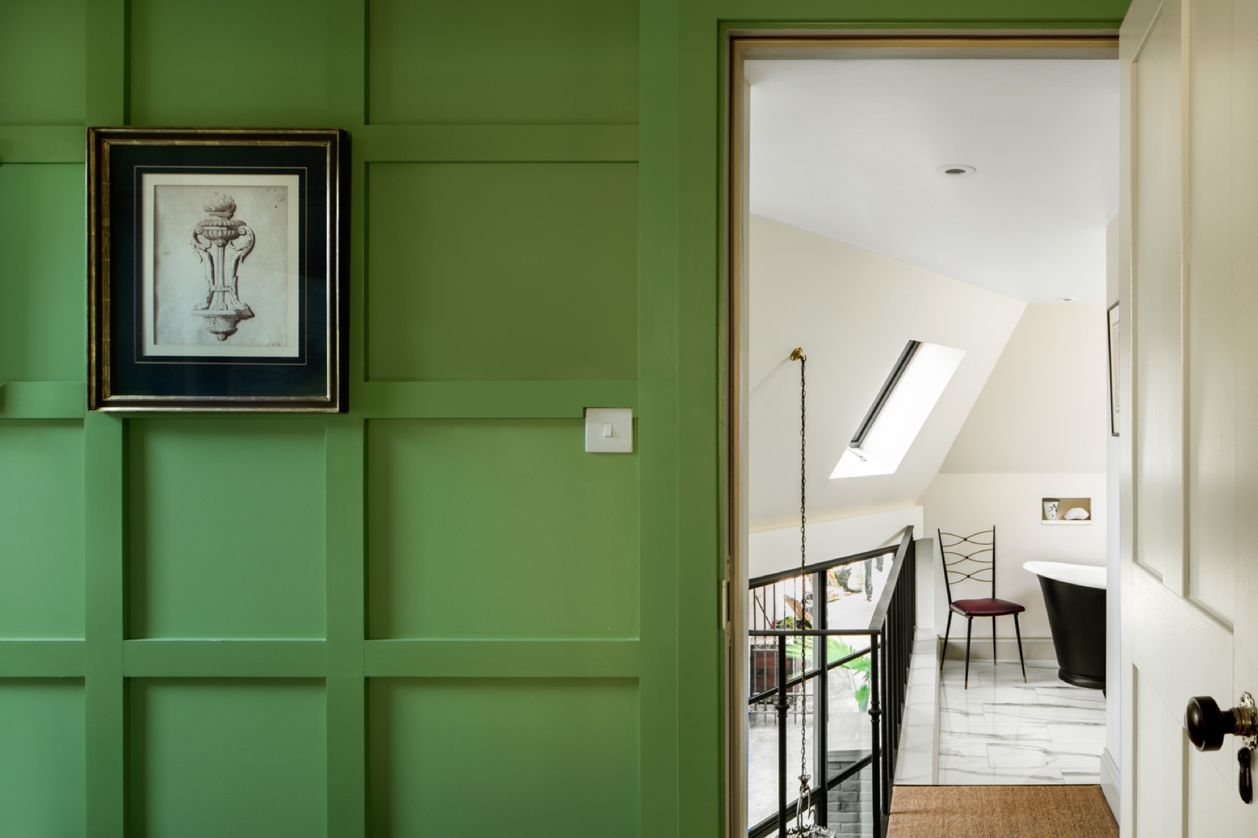 Green panelled landing leading to a loft bathroom, loft conversion in Hackney